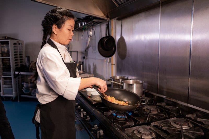 Bristol Catering Agency A chef frying food in a wok