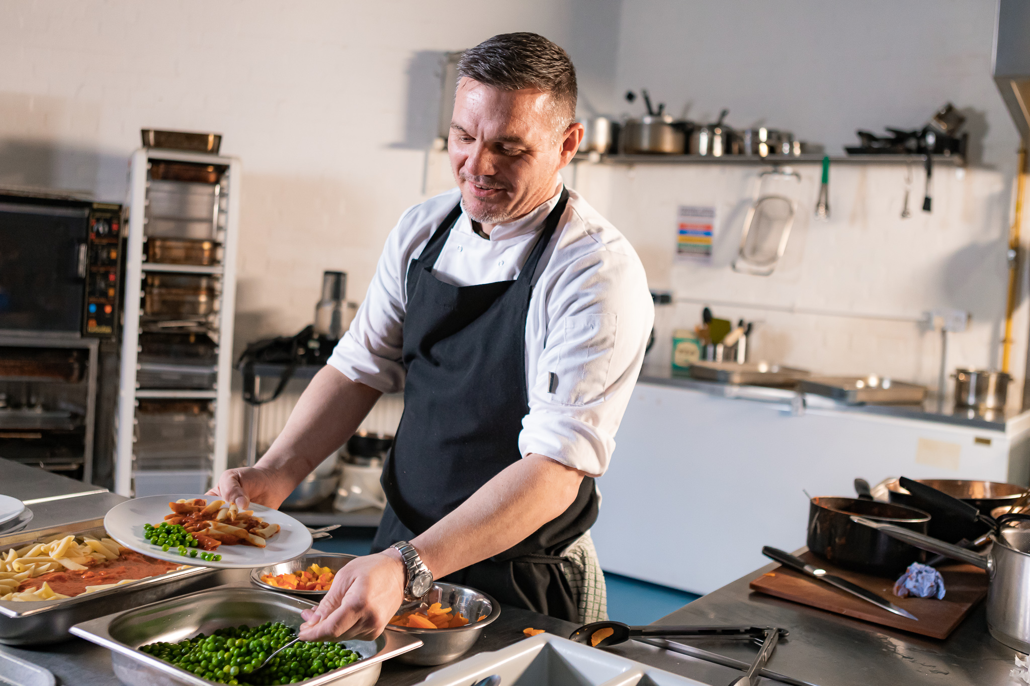 A chef frying food in a wok